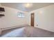 Empty bedroom with neutral carpet, small window, and a single door at 1715 Alkire St, Golden, CO 80401