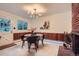 Charming dining area with modern light fixture, brick fireplace, and access to backyard at 1715 Alkire St, Golden, CO 80401