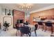 Open dining area next to kitchen featuring modern lighting and brick fireplace at 1715 Alkire St, Golden, CO 80401