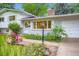 Close up of home with brick facade, garden, flower beds, and new landscaping at 1715 Alkire St, Golden, CO 80401
