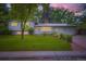 Beautiful home with a well-manicured lawn and garden beds, enhanced by decorative outdoor lighting at 1715 Alkire St, Golden, CO 80401