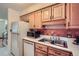 Practical kitchen with stainless steel sink, tile backsplash, and white appliances at 1715 Alkire St, Golden, CO 80401
