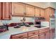 Functional kitchen featuring wood cabinets and an electric cooktop on a white countertop at 1715 Alkire St, Golden, CO 80401