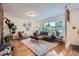 Bright living room with hardwood floors, large window, and comfortable seating at 1715 Alkire St, Golden, CO 80401