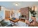 Inviting living room with hardwood floors, brick fireplace, and staircase at 1715 Alkire St, Golden, CO 80401