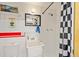 Garage bathroom with utilitarian sink and shower and checkered design at 6480 W 60Th Ave, Arvada, CO 80003