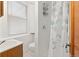 Bathroom featuring a white vanity, toilet, shower stall, and window for natural light at 6480 W 60Th Ave, Arvada, CO 80003