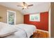 Cozy bedroom with hardwood floors, two windows, and a ceiling fan with light at 6480 W 60Th Ave, Arvada, CO 80003