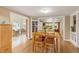 Open dining area with hardwood floors and access to sunroom offering plenty of natural light at 6480 W 60Th Ave, Arvada, CO 80003