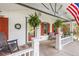Welcoming front porch with rocking chair, fern decor, and cozy seating area at 6480 W 60Th Ave, Arvada, CO 80003
