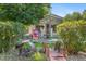 Charming front yard with a decorative bridge, lush greenery, and inviting curb appeal at 6480 W 60Th Ave, Arvada, CO 80003