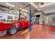 Well-equipped garage with car lift, work area, and ample space for automotive projects at 6480 W 60Th Ave, Arvada, CO 80003