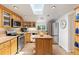 Bright kitchen with stainless steel appliances, skylight, and functional island perfect for cooking and entertaining at 6480 W 60Th Ave, Arvada, CO 80003