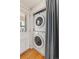 Laundry area with stackable washer and dryer in a closet near a window and door at 6480 W 60Th Ave, Arvada, CO 80003