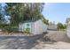 Outbuilding with double doors and adjacent parking featuring a small garden at 6480 W 60Th Ave, Arvada, CO 80003