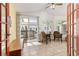Bright sunroom features tile flooring, ceiling fan, and sliding doors to a wood deck at 6480 W 60Th Ave, Arvada, CO 80003