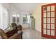 Bright sunroom features tile flooring, multiple windows, and a colorful accent wall at 6480 W 60Th Ave, Arvada, CO 80003