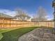 Spacious backyard featuring artificial turf, wood fence, and a flagstone patio at 16564 High Desert Way, Parker, CO 80134