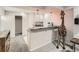 Wet bar featuring stone countertop, neutral cabinetry, and adjacent seating area at 16564 High Desert Way, Parker, CO 80134