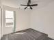 Cozy bedroom featuring plush carpet, neutral walls, a window, and a ceiling fan at 16564 High Desert Way, Parker, CO 80134