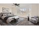 Cozy bedroom with large windows, plush carpet, ceiling fan and stylish furnishings at 16564 High Desert Way, Parker, CO 80134