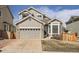 Attractive home exterior with a well-maintained lawn, stone accents, and an attached two-car garage at 16564 High Desert Way, Parker, CO 80134