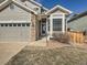 Inviting home exterior featuring a well-manicured lawn, updated stonework, and a charming front entrance at 16564 High Desert Way, Parker, CO 80134