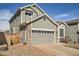 Charming home exterior with a two-car garage, stone accents, and well-maintained landscaping at 16564 High Desert Way, Parker, CO 80134