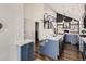 Modern kitchen featuring blue cabinets, white countertops, stainless steel appliances, and wood floors at 16564 High Desert Way, Parker, CO 80134