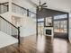 Spacious living room with hardwood floors, a fireplace, a second-story balcony, and plenty of natural light at 16564 High Desert Way, Parker, CO 80134