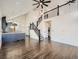 Open-concept living space with hardwood floors, staircase, modern finishes, and a view of the kitchen at 16564 High Desert Way, Parker, CO 80134