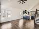 Spacious living room with hardwood floors, vaulted ceilings, many windows, and an open view to the kitchen at 16564 High Desert Way, Parker, CO 80134