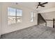 Open loft area with plush carpet, large windows, neutral walls, and stylish railing at 16564 High Desert Way, Parker, CO 80134