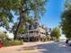 Charming building with detailed architecture, featuring balconies, a clock tower, and storefronts, on a sunny day at 16564 High Desert Way, Parker, CO 80134