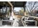 Covered porch features comfortable seating, stylish decor, and offers an inviting outdoor relaxation space at 2495 S Madison St, Denver, CO 80210