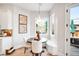 Cozy breakfast nook featuring a built-in bench, a round table, and ample natural light at 2495 S Madison St, Denver, CO 80210