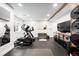 Well-equipped home gym with fitness equipment, TV, and ample workout space at 2495 S Madison St, Denver, CO 80210