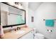 Bright bathroom features a large vanity, stylish lighting, and modern design at 2495 S Madison St, Denver, CO 80210