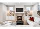 Inviting living room features a cozy fireplace and custom built-in shelving at 2495 S Madison St, Denver, CO 80210