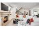 Bright living room features a stone fireplace and a comfortable white sectional sofa at 2495 S Madison St, Denver, CO 80210
