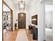 Inviting foyer with hardwood floors, a decorative wood door, and access to other rooms at 2495 S Madison St, Denver, CO 80210
