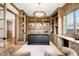 Spacious home office with custom built-in bookshelves and a large black desk at 2495 S Madison St, Denver, CO 80210