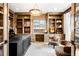 Bright home office featuring custom built-in shelves and work space with desk and cozy chairs at 2495 S Madison St, Denver, CO 80210