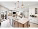 Gourmet kitchen boasting a large island, stainless steel appliances, and an open floor plan at 2495 S Madison St, Denver, CO 80210