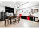 Organized garage with TVs, workspace, refrigerator, tool storage, and epoxy floor offers versatile functionality at 2495 S Madison St, Denver, CO 80210