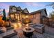 Backyard patio boasts fire pit, comfortable seating, and ambient lighting, perfect for outdoor enjoyment at 2495 S Madison St, Denver, CO 80210