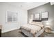 Neutral bedroom boasts a queen bed, three modern art pieces, and a window for natural light at 2495 S Madison St, Denver, CO 80210