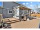 Backyard featuring a sunroom, grill, patio, and gray siding on a home with blue skies at 4860 S Field Way, Littleton, CO 80123
