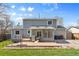 Backyard view with patio, grill, green grass, and back of house with sunroom at 4860 S Field Way, Littleton, CO 80123