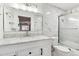 Bright bathroom featuring marble tile, a glass-enclosed shower, and a modern vanity with storage at 4860 S Field Way, Littleton, CO 80123